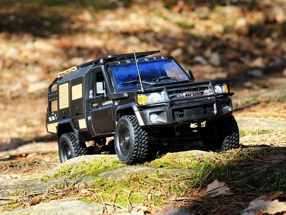 Čierne RC auto Toyota Land Cruiser v lese